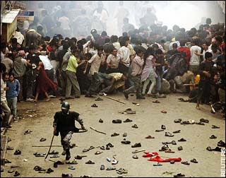 Nepal riot policeman runs away from protesters